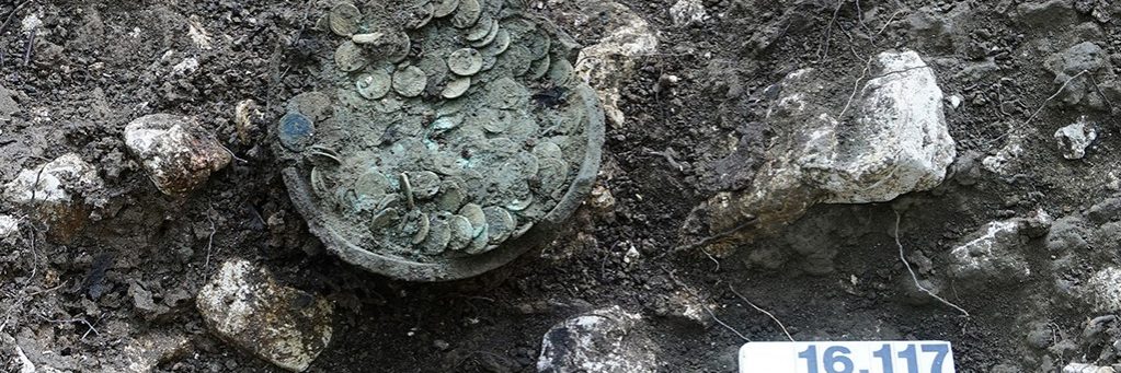 The ceramic pot with the coins after professional excavation by employees of Archaeology Baselland.