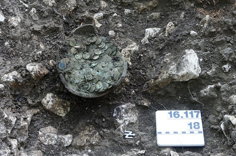 The ceramic pot with the coins after professional excavation by employees of Archaeology Baselland.