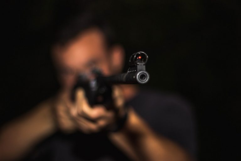 Man holding assault rifle