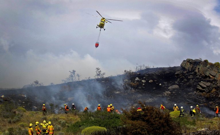 Firefighters and a rescue helicopter aiding Chile wildfires.