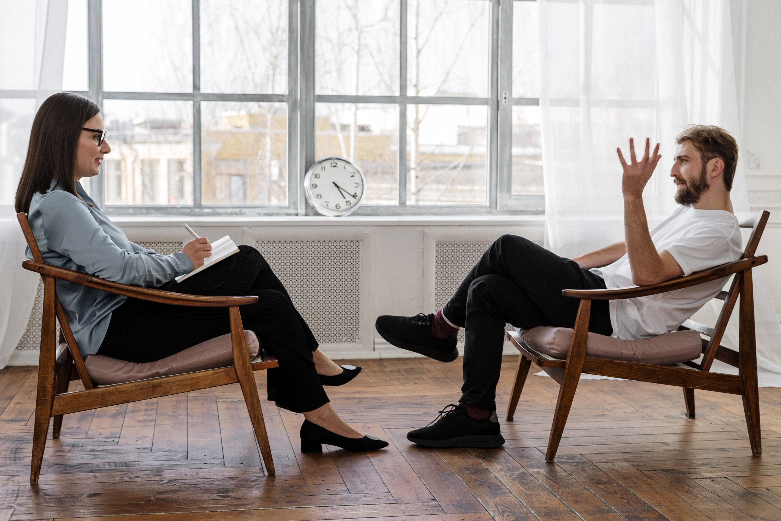 Man obtaining mental health services from a woman