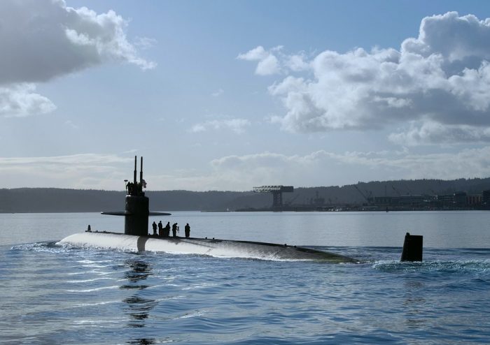 A nuclear submarine on the surface of the water.