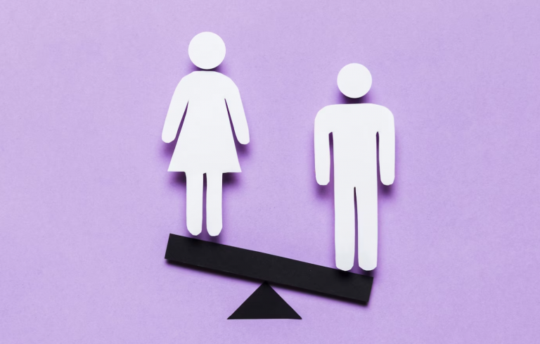 Male and female figures on a skewed see saw to represent gender inequality and bias.