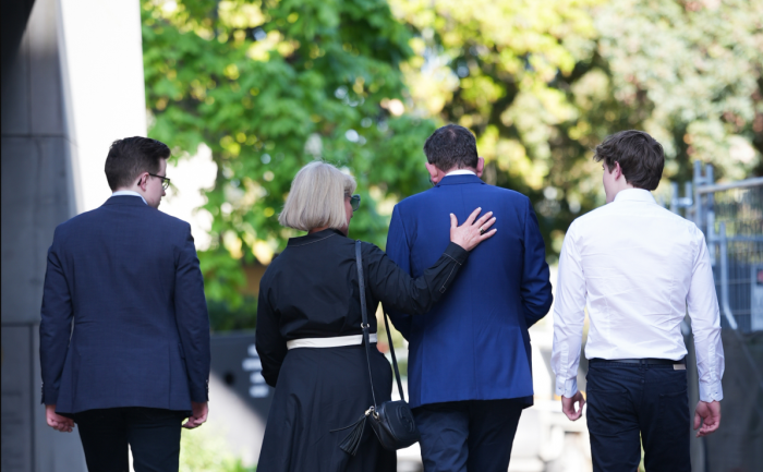 Dan Andrews and family walk away from parliament.