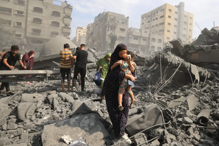 Palestinian woman carries child in Gaza Strip after Israeli retaliation for Hamas attacks