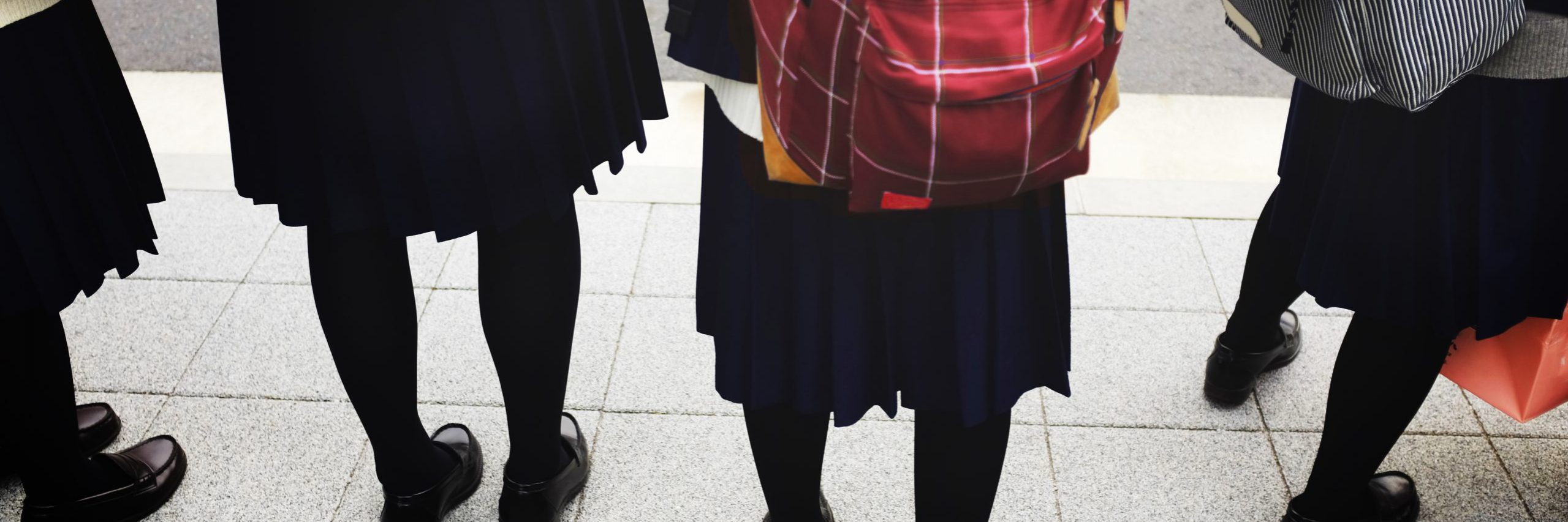 Students in school uniform with backpacks