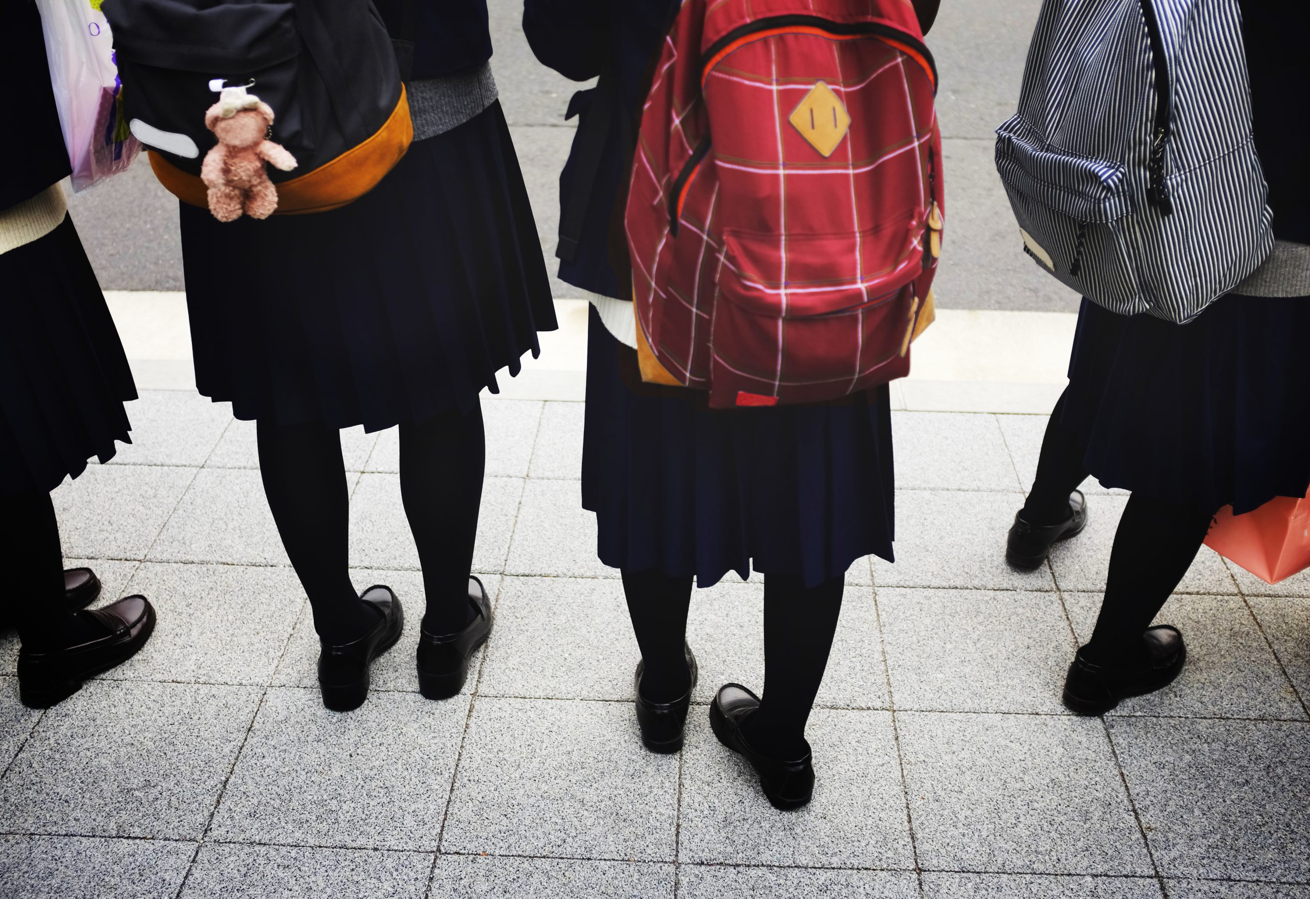 Students in school uniform with backpacks