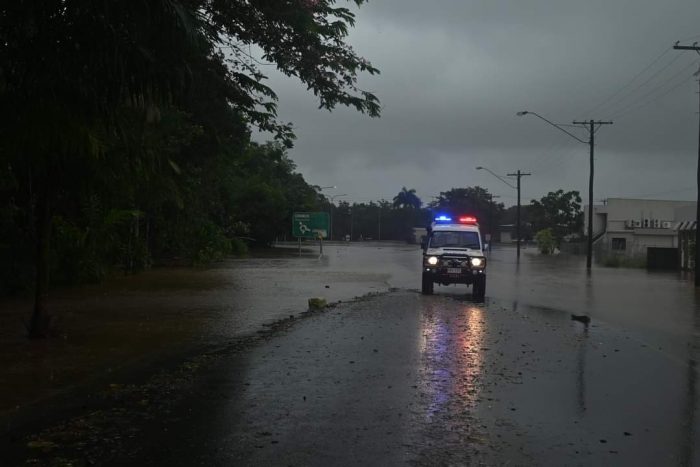 Police block a road that has flooded in Innisfail