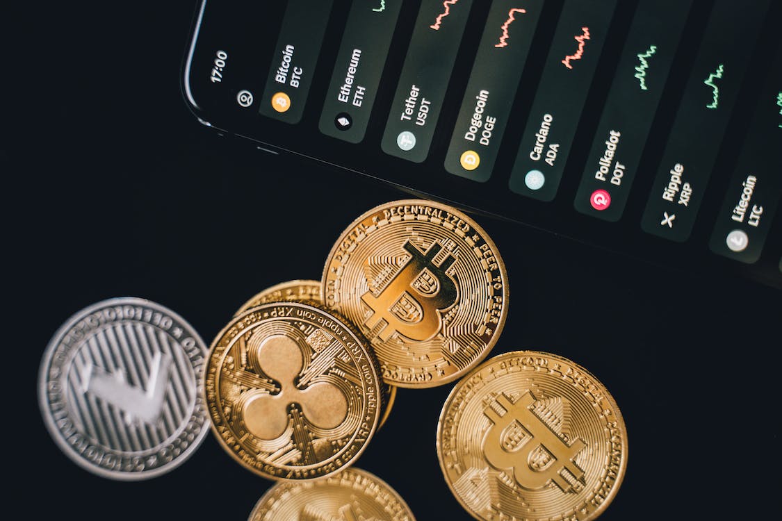 Bitcoins beside a smartphone