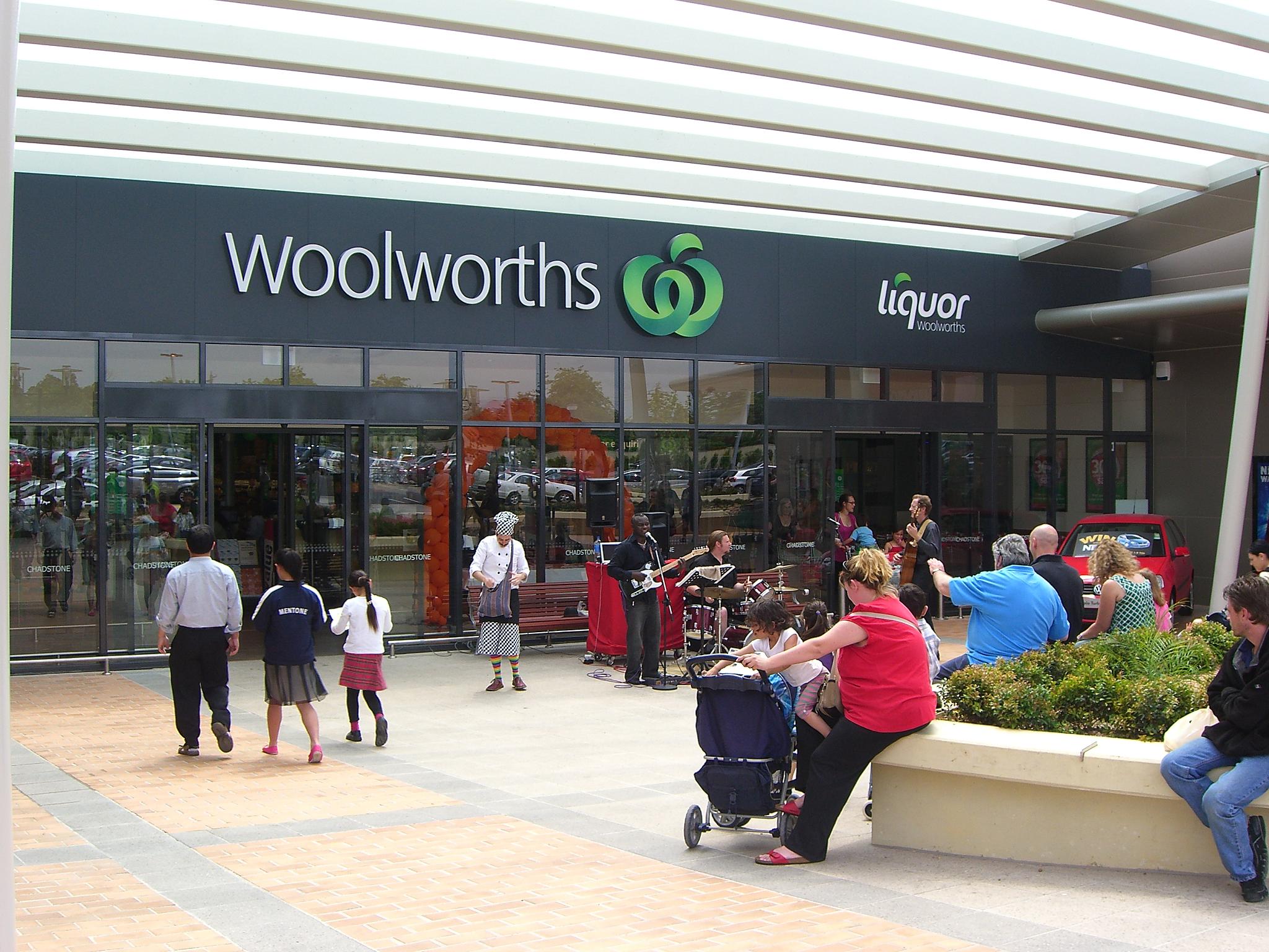 a crowd of people around entrance to Woolworths
