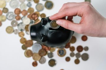 money being put in a piggy bank