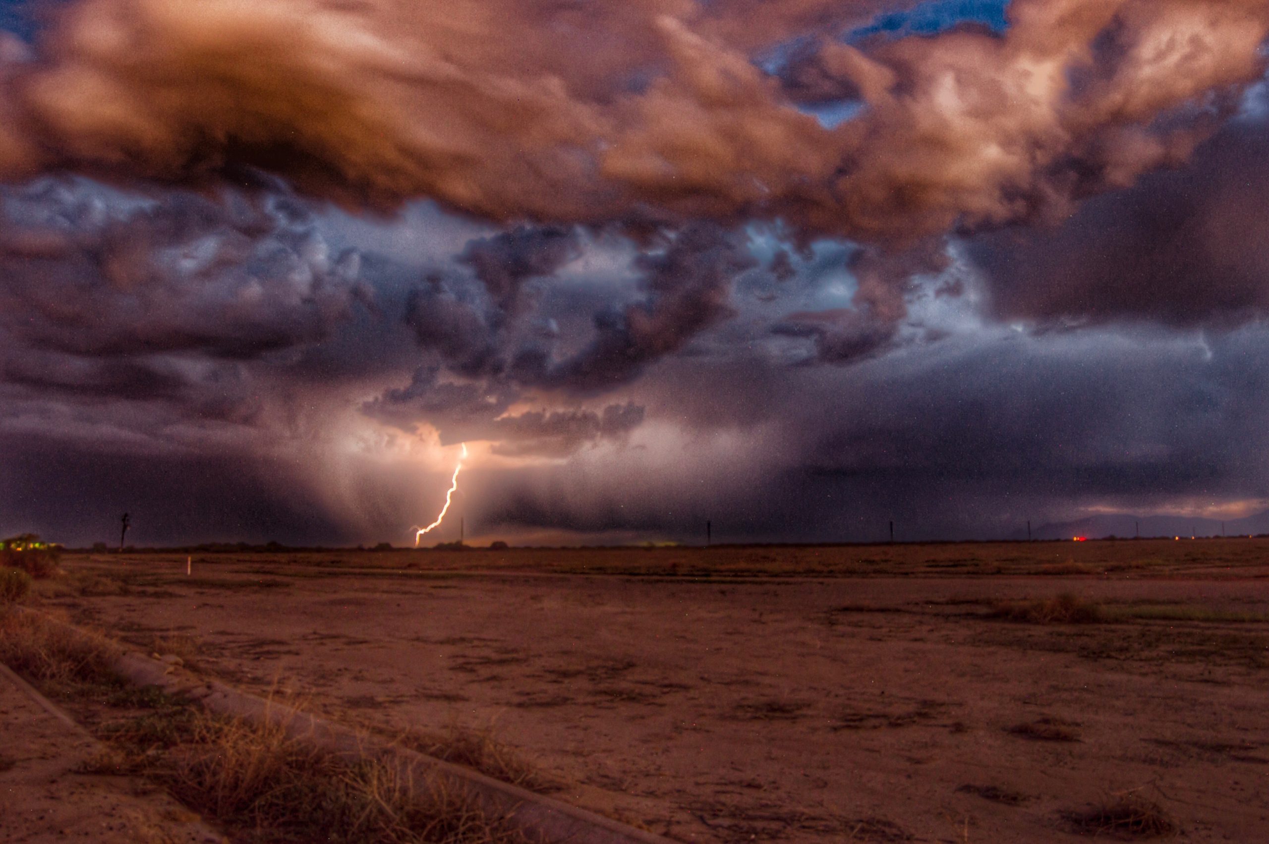 lightning from storm clouds over outback prevents search for missing people