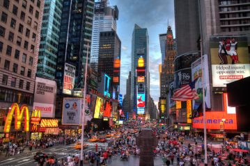 New York City's Times Square lit up with many signs, advertisements, and billboards. Image source: Terabass. via Wikimedia Commons