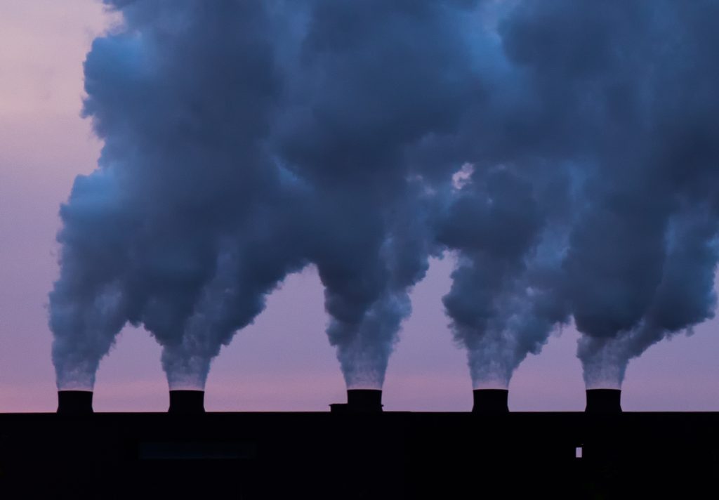 Smoke stacks at the Cleveland-Cliffs Northshore Mining Company in Silver Bay, Minnesota. The smoke stacks are pumping pollutants into the air as byproduct from creating fossil fuel.