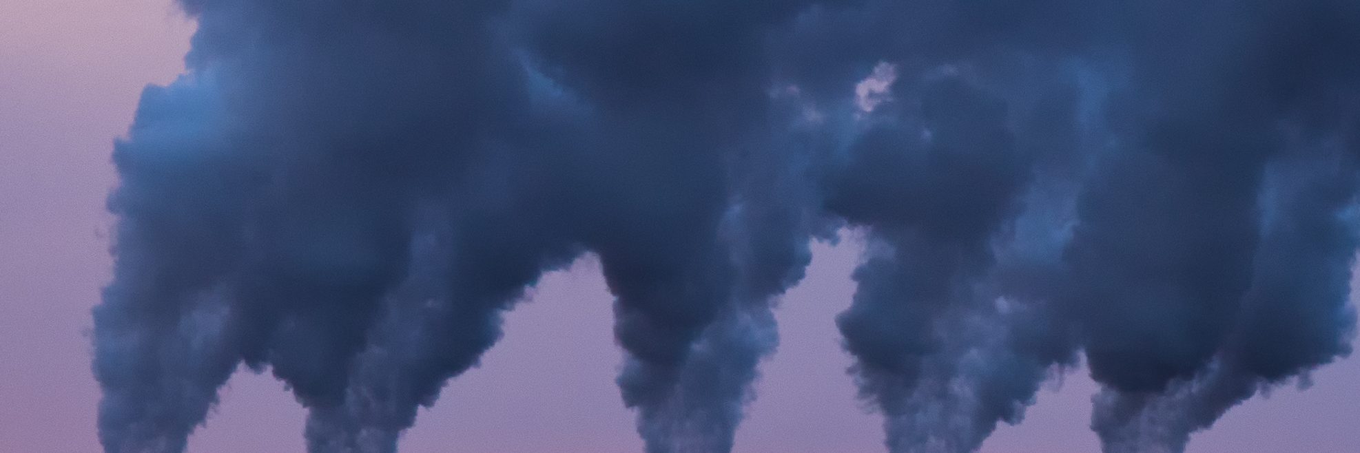 Smoke stacks at the Cleveland-Cliffs Northshore Mining Company in Silver Bay, Minnesota. The smoke stacks are pumping pollutants into the air as byproduct from creating fossil fuel.