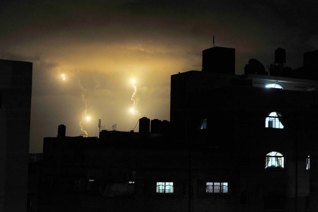 Flares from Israeli forces light up the night sky of Gaza City