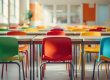 Colorful chairs surround tables in bright, vibrant classroom. Australia's literacy levels require government action. Image Source: Rorozoa, via Freepik