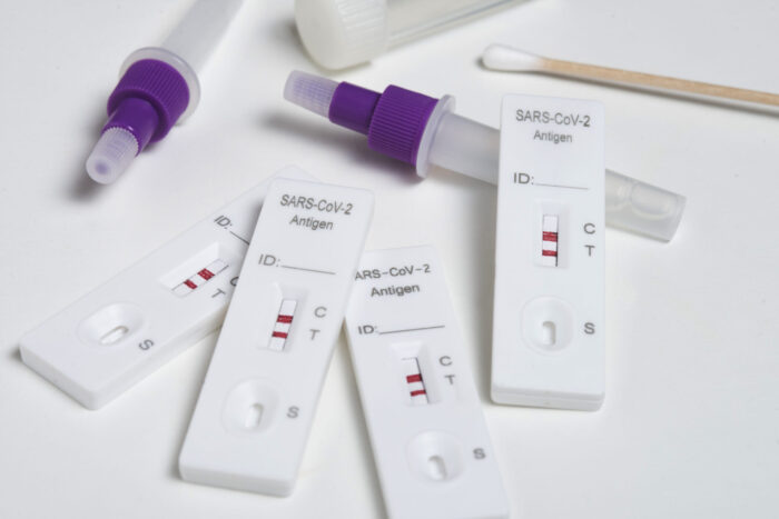 a collection of positive covid tests, also called rapid antigen tests, or RATs. Image source: freepik, via Freepik.