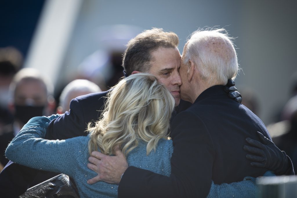 An image of US President Joe Biden hugging his family during the 59th Presidential Inauguration ceremony in Washington, Jan. 20, 2021. Image source: Chairman of the Joint Chiefs of Staff, via Wikimedia Commons