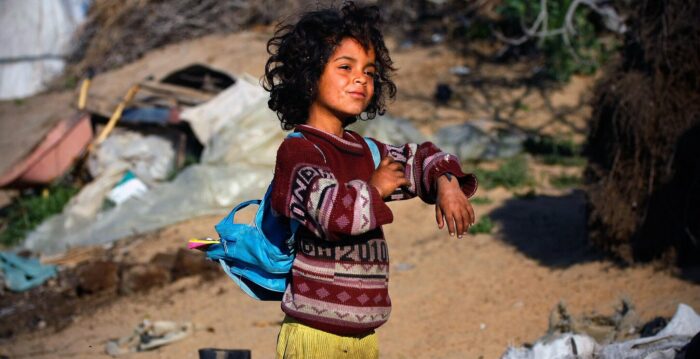 Sabha,6, getting ready to walk to school from her house on the borders eastern Gaza strip, where she and her family are still living in tents after Israeli war in Gaza.