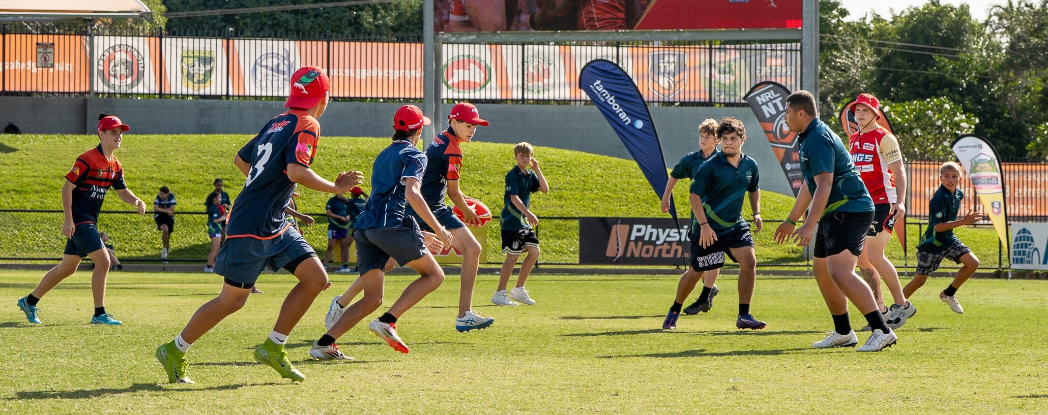The Brisbane Dolphins run young fans through some drills at a schools competition, shortly after the announcement of the Dolphins partnering with the Northern Territory Government to play a series of home games at Territory Rugby League Stadium. The Brisbane Dolphins run a drills session for school students. Photo credit: NT Major Events Company: Verity Griffin