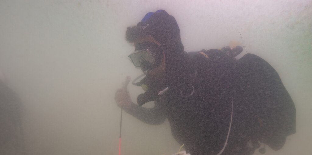 SA Principal Maritime Heritage Officer Mark Polzer probes the seabed with a metal detector. Photo: Ruud Stelten