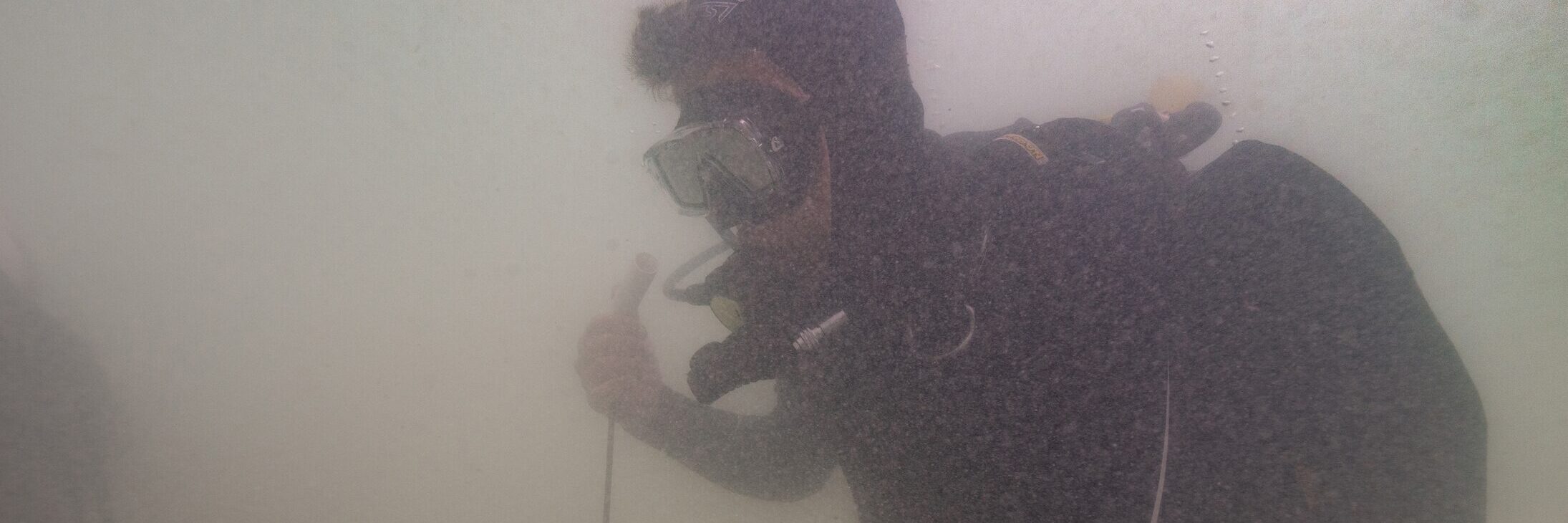 SA Principal Maritime Heritage Officer Mark Polzer probes the seabed with a metal detector. Photo: Ruud Stelten