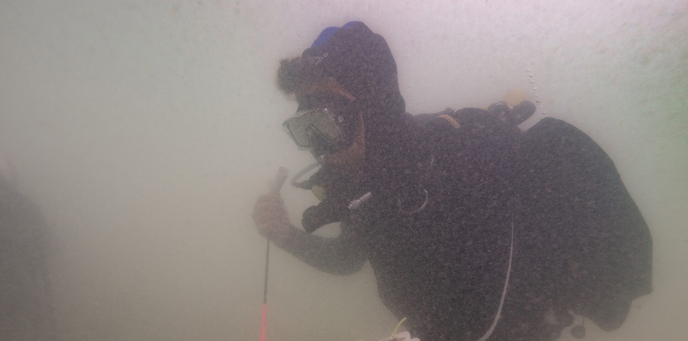 SA Principal Maritime Heritage Officer Mark Polzer probes the seabed with a metal detector. Photo: Ruud Stelten