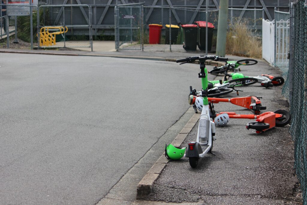 Electric scooters next to a rail station in suburban Brisbane, Queensland. Photo: ANDREW KACIMAIWAI