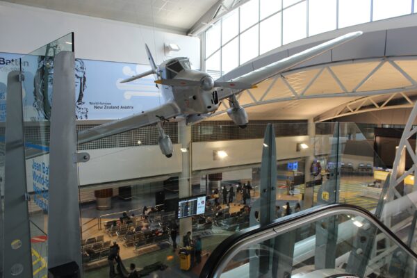 Kiwi aviatrix Jean Batten’s aircraft hangs over the concourse at Auckland Airport. Photo: ANDREW KACIMAIWAI