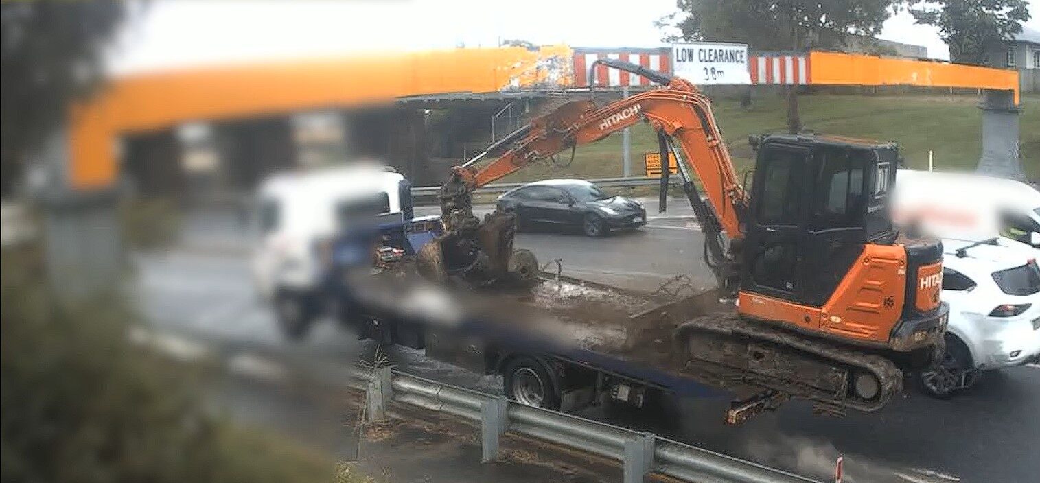 An excavator strikes a beam and comes off this truck on Muriel Ave at Rocklea, SEQ, on April 14, 2025. Image: Qld Rail