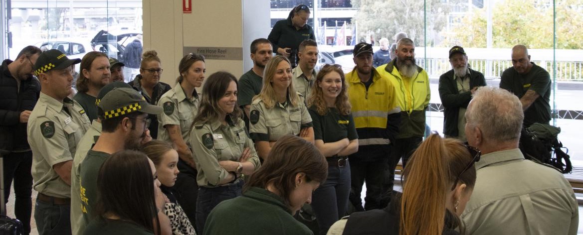 Victorian firefighters are briefed ahead of their departure to Canada via Brisbane. Photo: Vic Emergency