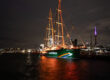 The Rainbow Warrior lights up at dawn today (July 10, 2025) in Auckland Harbour. Photo: Bryce Groves/Greenpeace