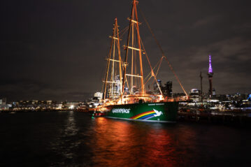 The Rainbow Warrior lights up at dawn today (July 10, 2025) in Auckland Harbour. Photo: Bryce Groves/Greenpeace