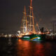 The Rainbow Warrior lights up at dawn today (July 10, 2025) in Auckland Harbour. Photo: Bryce Groves/Greenpeace