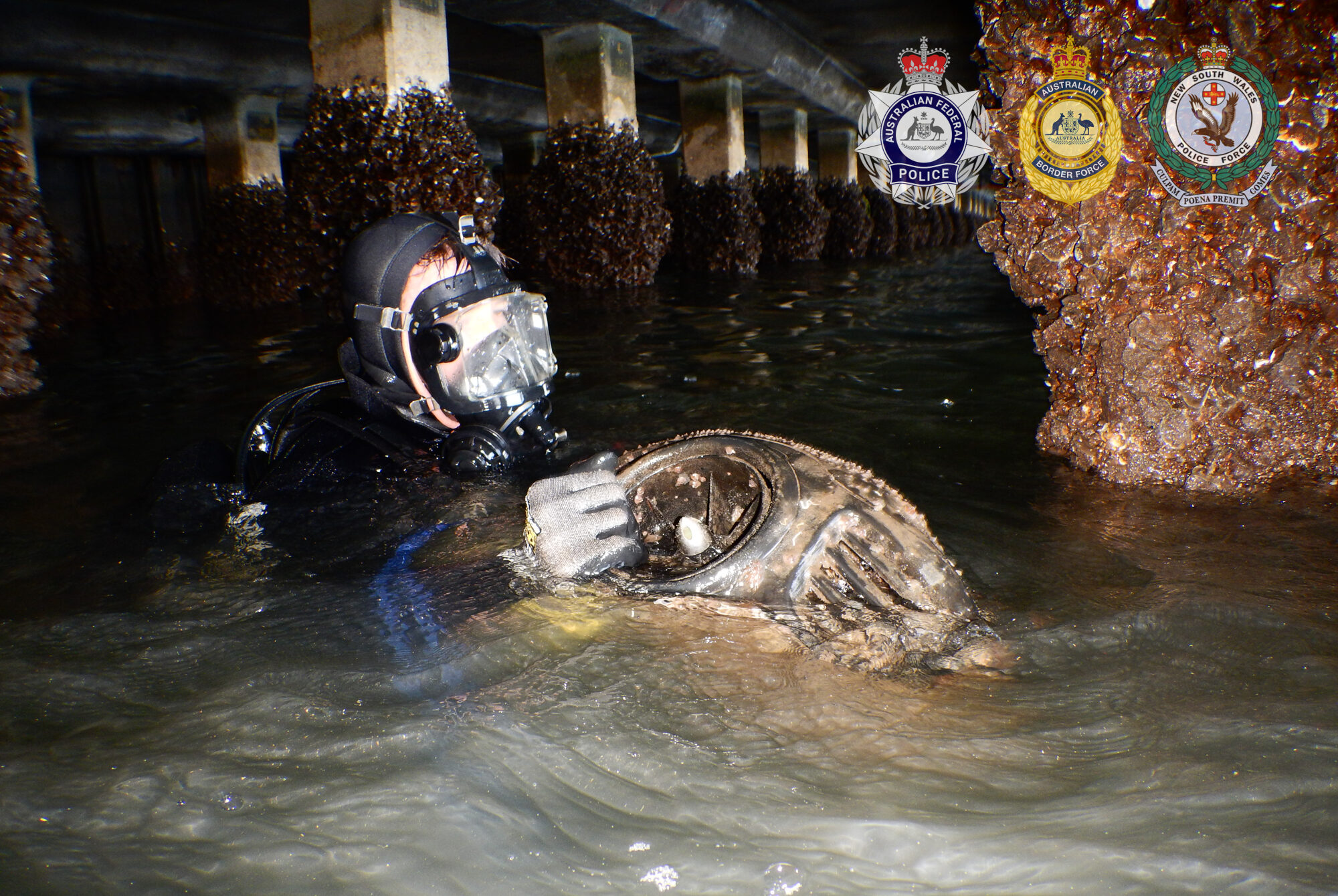 A Norwegian's diver's Seabob scooter is retrieved from a pylon in the Hunter River. Photo: AFP