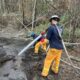 Queensland firefighters dousing the ground in Canada last year. Photo: Qld Fire Department