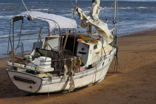 The damaged yacht stranded at Margate Beach, Redcliffe, on Sunday, August 10, 2025. NB: Name blurred to protect privacy. Photo: ANDREW KACIMAIWAI