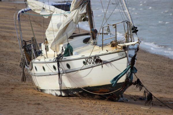 The damaged yacht stranded at Margate Beach, Redcliffe, on Sunday, August 10, 2025. NB: Name blurred to protect privacy. Photo: ANDREW KACIMAIWAI