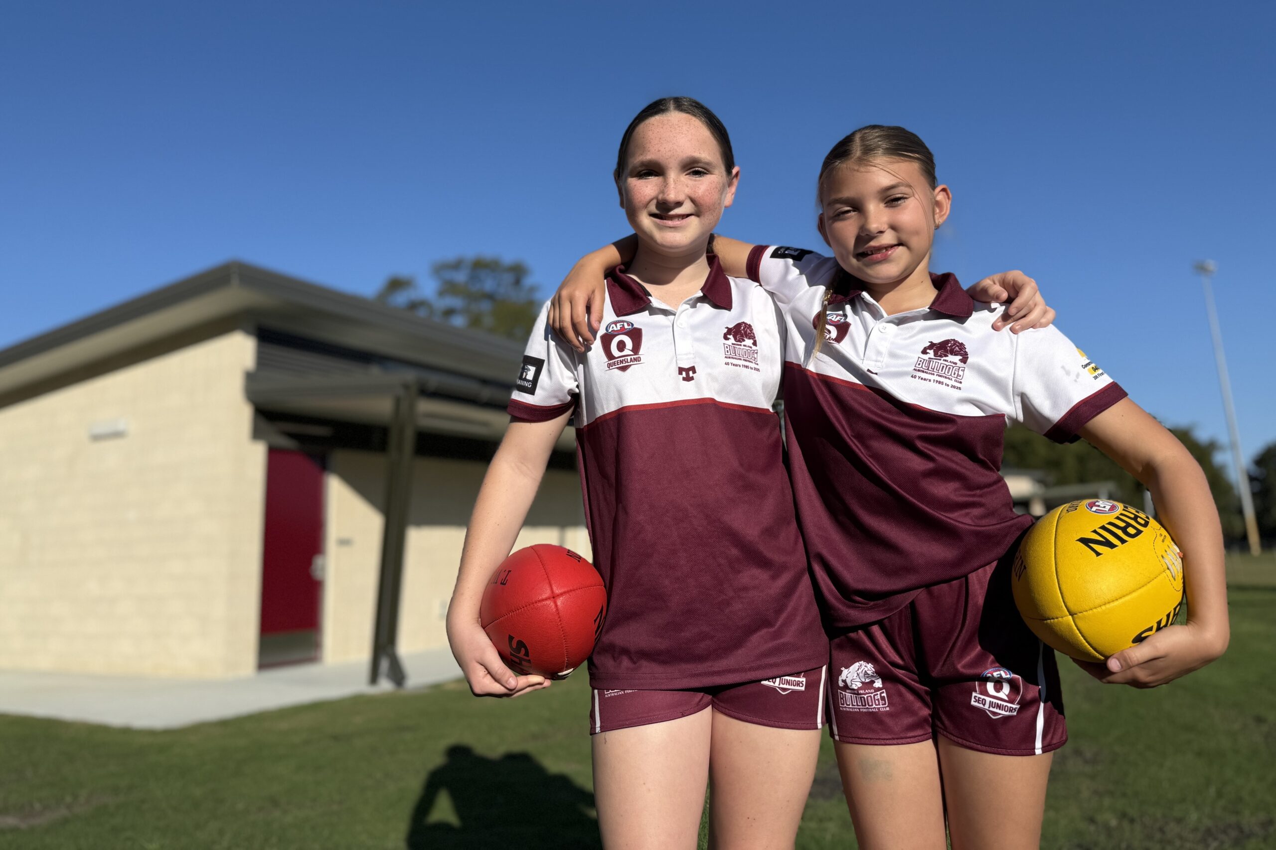 Bribie Island Bulldogs Summer McGrath and Ayva Anderson out the front of the new $1.8m change rooms. Photo: MBCC