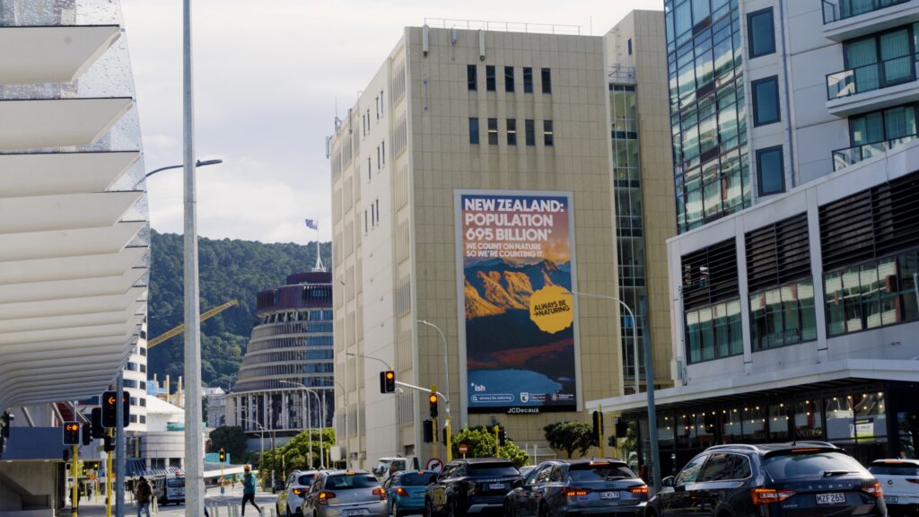 One of the campaign digital billboards in Wellington, New Zealand, with Parliament House in the background.