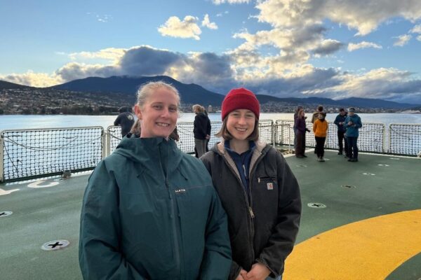 Jenny Bonser and Samantha Climie onboard the RSV Nuyina as it sails out of Hobart. Photo: Bec Hewett