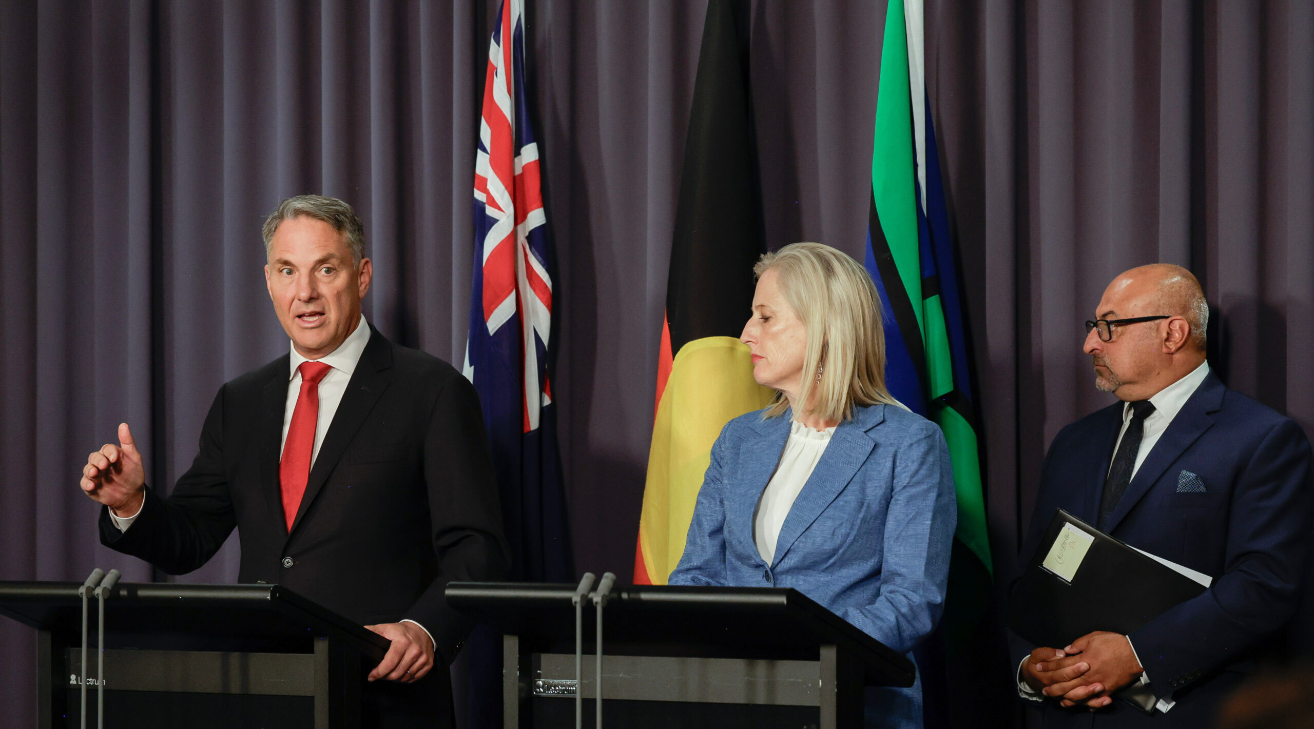land sale ... Defence Minister Richard Marles (left), Finance Minister Senator Katy Gallagher and Assistant Defence Minister Peter Khalil at a press conference at Parliament House in Canberra. Photo: Department of Defence