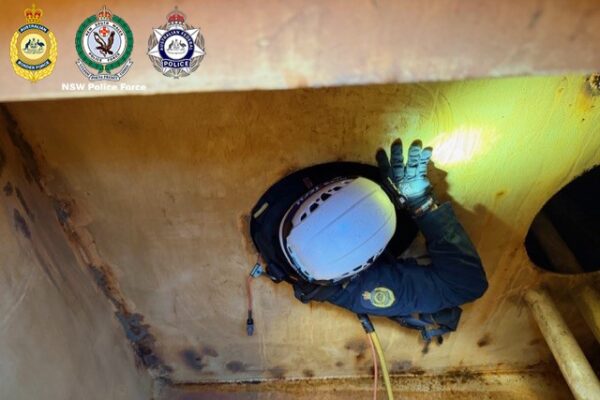 crew ... Police officials search the vessel at anchor in Sydney Harbour. Photos: supplied.