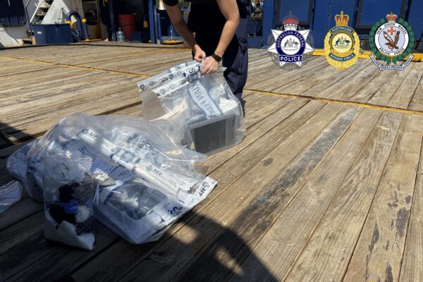 crew... Police officials search the vessel at anchor in Sydney Harbour. Photos: supplied.