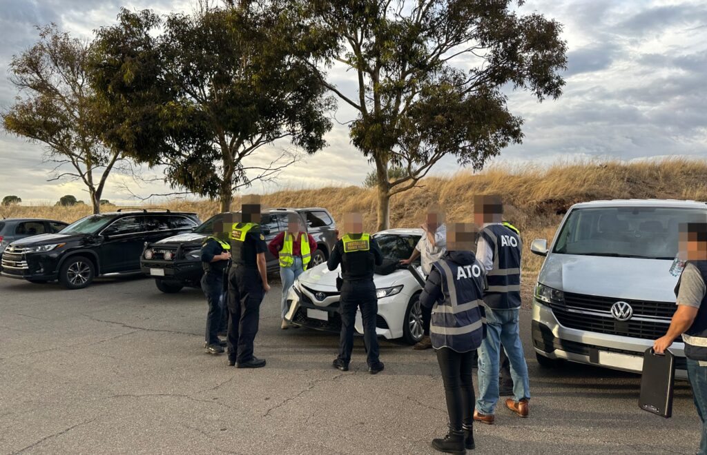 Federal officers talk to staff and workers at one of the SA vineyards as part of Operation Zephyr. Photo: ATO/supplied.
