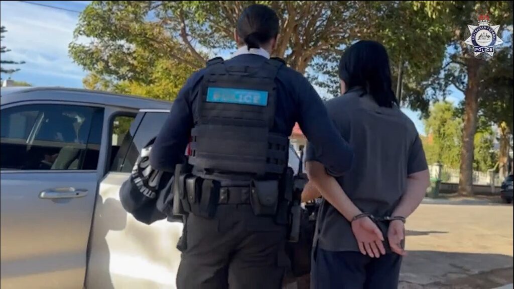A South Australian reservist is taken into custody by AFP officers. Footage: AFP.
