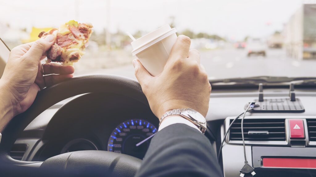 Eating behind the wheel was rated the top of many distractions in the survey. Photo: jcomp on Magnific.