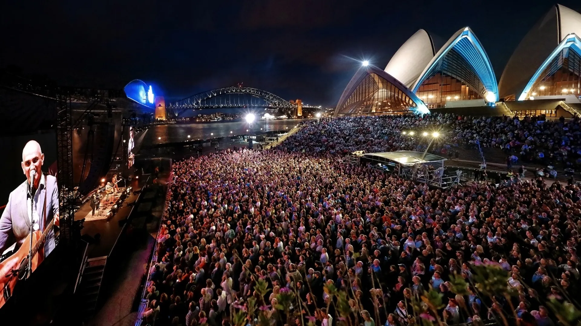 FILE … Paul Kelly performing at the opera house forecourt in 2017. Photo: Prudence Upton/Sydney Opera House.