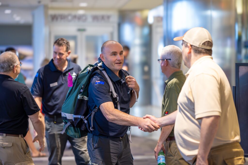 Aussie and Kiwi firefighters are greeted upon their arrival in Boise, Idaho. They will spend 30 days helping US crews. Photo: Caleb Ashby/DOI